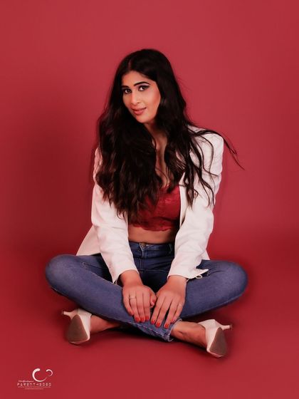 A classic, full-frame seated portrait that is both elegant and approachable. The styling is timeless and chic.