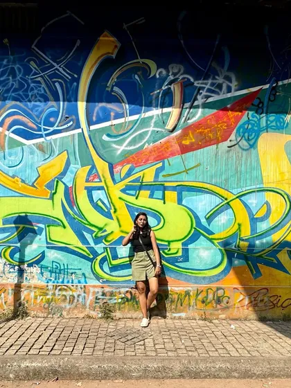 A traveler posing against the cool graffiti in Kannur, showcasing the artistic side of our cultural explorations.