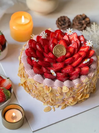 The full Fresh Cream Strawberry Cake, adorned with sliced almonds and a crown of fresh strawberries. It's a classic beauty and a celebration of the strawberry season.