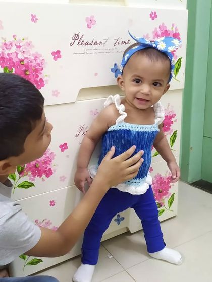 A sweet moment between siblings. My daughter is wearing the Cotton Candy Dream Top, which features lovely ruffled straps and a comfortable fit, perfect for everyday wear.