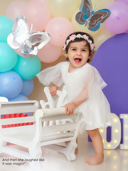 And then she laughed like it was magic. The pure joy of a first birthday celebration is beautifully captured in this happy shot.