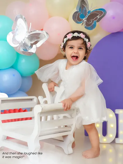 And then she laughed like it was magic. The pure joy of a first birthday celebration is beautifully captured in this happy shot.