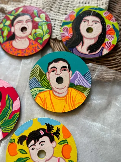 These quirky custom coasters feature portraits of each family member with a fun, open-mouthed expression. It's a playful twist on the traditional family portrait.
