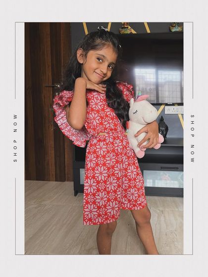 Another look at our red floral jumpsuit, perfect for little fashionistas. It's soft, breathable, and utterly comfortable for any adventure.