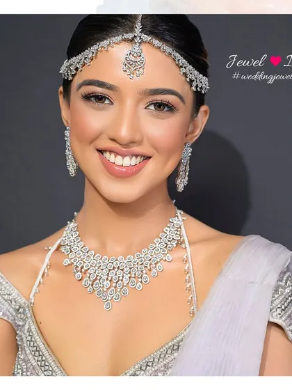 The complete diamond set, featuring a beautiful cascading necklace, matching earrings, and sheeshpatti. This look is all about creating a cohesive, sparkling statement for the modern bride.