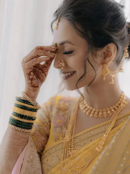A happy, shy smile from the bride, this close-up captures the essence of her soft and natural look.