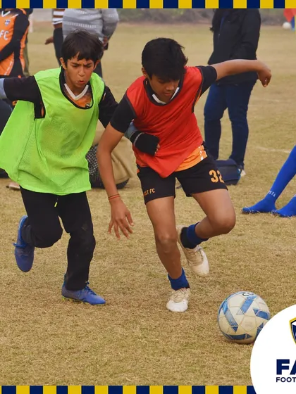 An intense moment of play, with our player shielding the ball from a determined opponent.