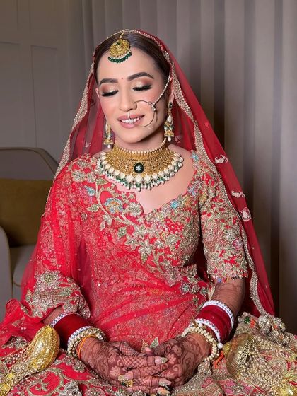 A moment of quiet reflection. The makeup is soft yet defined, with a beautiful smile that shows her happiness and confidence.