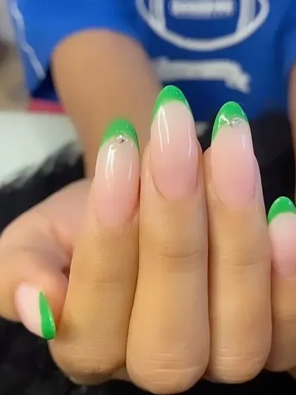 Bold neon green French tips with a small rhinestone at the cuticle for a touch of sparkle.