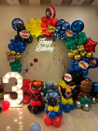 We assembled the entire Avengers team for this superhero-themed birthday party. The setup features a circular balloon arch in signature hero colors, character balloon sculptures of Spider-Man and Iron Man, a light-up marquee number '3', and a custom 'Happy Birthday' neon sign.