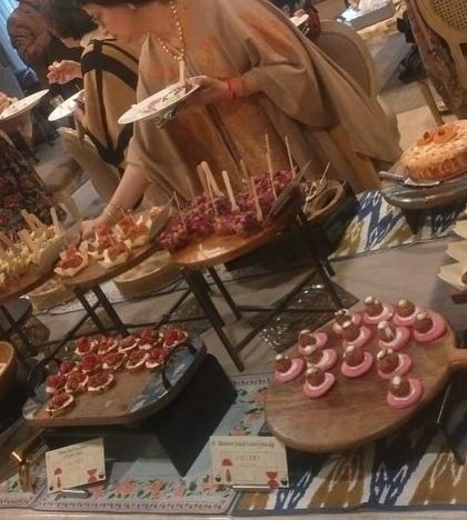 Another shot of guests enjoying the high-tea buffet. The spread is designed to offer a wide variety of flavors and textures in an elegant, easy-to-eat format.