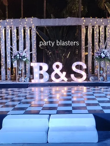 Let's make your Sangeet or reception truly personal with giant marquee letters of your initials. Paired with a checkered dance floor and dramatic lighting, this setup creates a fun, modern vibe that invites everyone to celebrate.