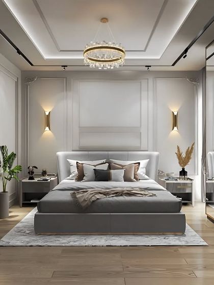 A beautifully appointed master bedroom with classic wall paneling and elegant gold-toned light fixtures. The design includes a full vanity station and a large wardrobe with mirrored doors, combining luxury and practicality.