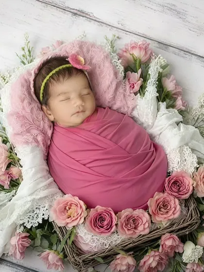 Surrounded by soft pink roses, this baby girl looks like a sleeping beauty. Floral themes are a wonderful way to add color and delicacy to a newborn session, and I always use high-quality, baby-safe props.