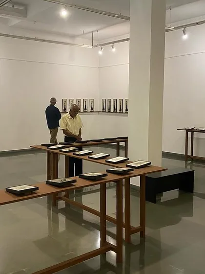 The gallery space during 'Quieter than Silence', with visitors contemplating the works from a distance.