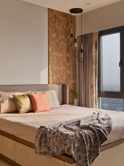 A serene parent's bedroom featuring a subtle yet elegant accent panel of natural wood tiles behind the bed. This small touch adds immense warmth and texture to the minimalist space.