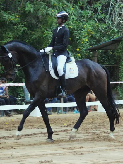 A young rider from my team during a dressage test at the Auroville Horse Show. His focused expression and correct posture are signs of a dedicated and well-coached equestrian.