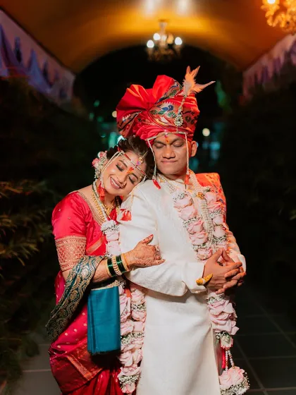 A tender moment captured at the end of the wedding day, with the bride resting her head on the groom's shoulder.