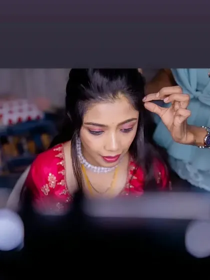 A behind-the-scenes shot of me doing Vasudha's reception makeup, focusing on a shimmery pink eye look.