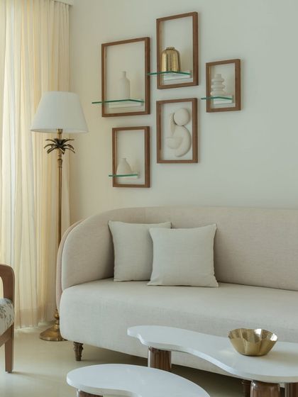 Details matter in a minimalist space. Here, a collection of empty wooden frames creates a unique wall art installation, adding texture and interest without overwhelming the serene aesthetic of the room.