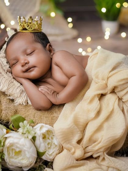 A smiling prince. This baby is having the sweetest dreams, complete with a tiny crown, in his cozy, rustic bed.