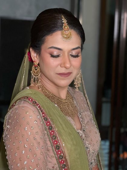 A close-up of the Kumaoni bride's makeup, with soft, earthy tones on the eyes and a natural, glowing base.