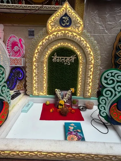 A beautiful, ready-made miniature mandir or 'makhar' for your idol. This ornate piece is lit from within and features intricate peacock designs, providing a divine throne for your deity.