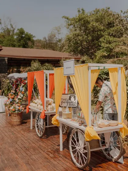 Fun food and activity carts, like this perfume bar, are a great way to make a Mehendi or carnival event interactive and memorable for guests.