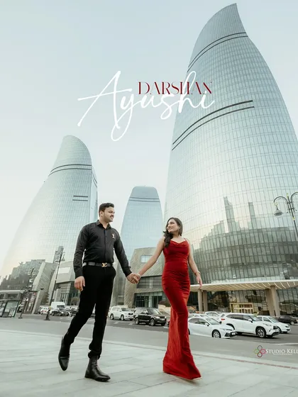 A powerful, modern pre-wedding portrait in Baku, Azerbaijan. The striking architecture of the Flame Towers provides a futuristic backdrop, while the couple's confident stride makes for a stylish, editorial-quality photograph.