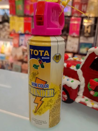 The 'Tota Mini Color Thunder' spray can. This is a smaller, more portable option for spraying color, perfect for personal use during Holi celebrations.