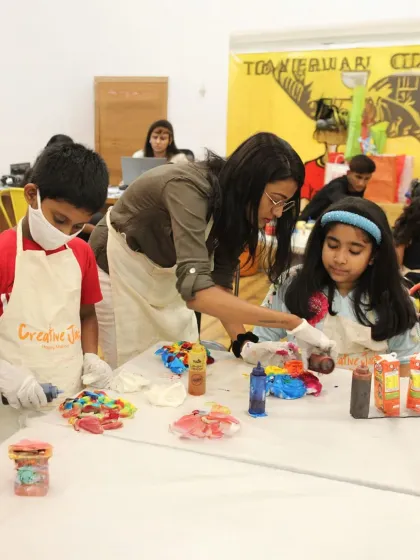 An instructor guides young artists during a tie-dye activity at a birthday party. I ensure everyone gets the help they need to bring their creative ideas to life.