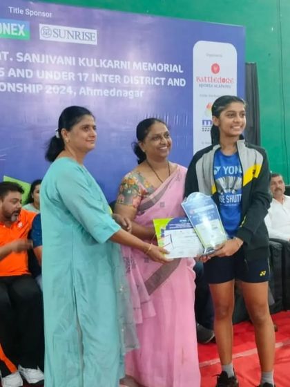 **Maharashtra State Champion.** Yashwi Patel receives her award after winning the Gold Medal in Girls' Singles U-15 in her home state of Maharashtra.