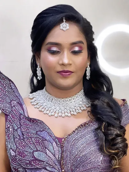 A unique reception gown with a butterfly-wing design. The makeup is equally dramatic with purple smokey eyes.