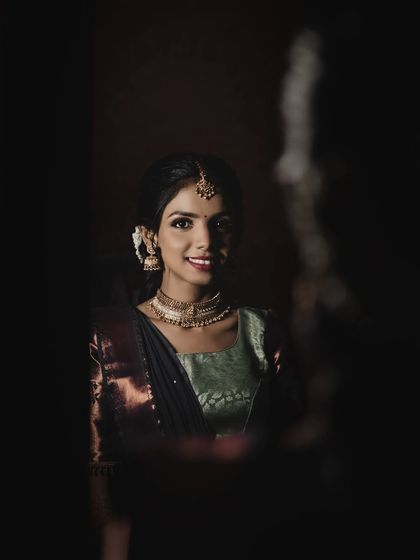 A beautiful, smiling close-up. The lighting catches the subtle shimmer in her makeup, making her look radiant.