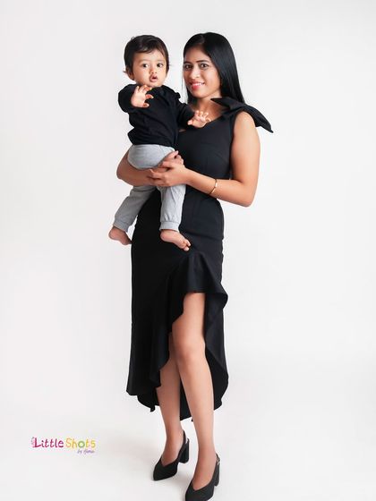 A full-length shot of a mother and son in a stylish pose. This demonstrates how we can create more fashion-forward portraits during a family session.