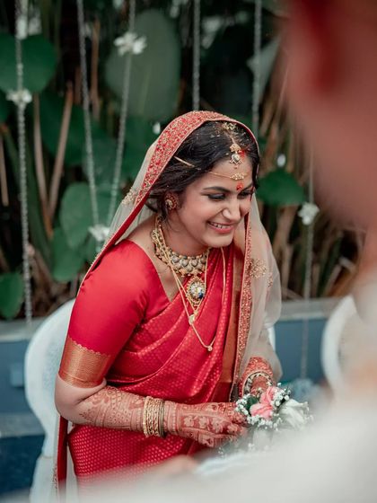 A candid shot of a bride's happy reaction as she looks at her groom during the ceremony.