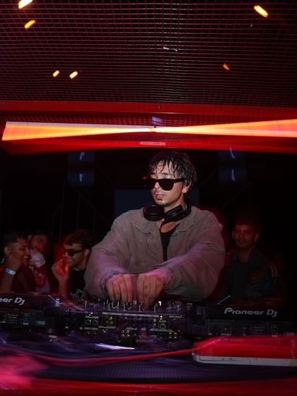 A focused shot of me at the console in Bangalore. Even in the midst of the party, my focus is on delivering a flawless set.