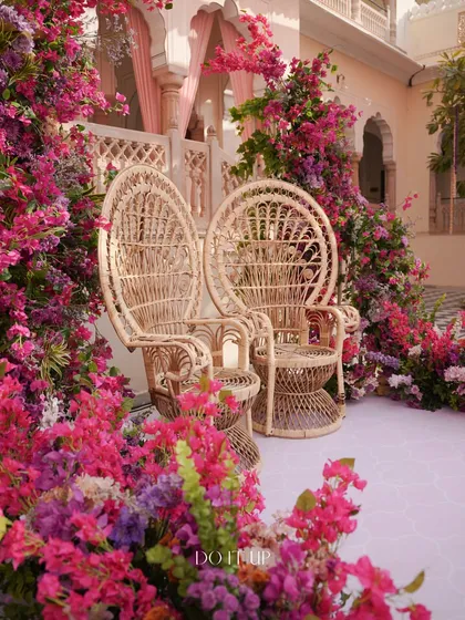 A closer look at the magnificent peacock chairs for the couple, enveloped in a cloud of vibrant pink bougainvillea. This was a true statement piece for the Jaipur Haldi.