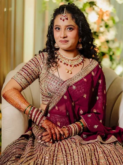 I believe in celebrating every bride's unique beauty, like natural curls. For this reception look, I enhanced her gorgeous curls and paired them with a soft glam makeup look, creating an elegant style that is both royal and personal.