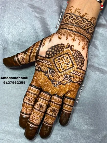 This unique design combines a Celtic knot in the center with traditional Indian peacock and lotus elements, showing how different styles can be blended beautifully.