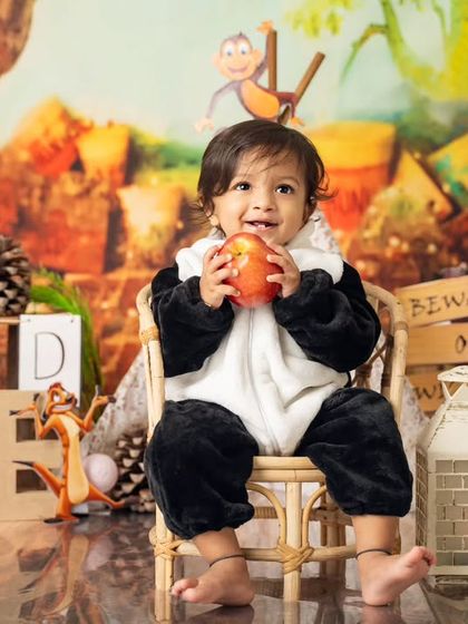 This little panda is enjoying a healthy apple snack before the cake. Our 'Wild One' jungle theme includes fun characters like Timon and Pumbaa.