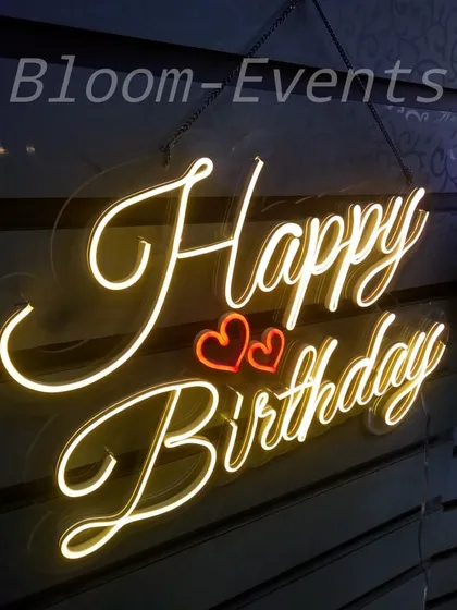 I offer a variety of neon signs for rent to add a personal touch to your event. This 'Happy Birthday' sign with glowing hearts is a popular choice for romantic birthday celebrations and serves as a great focal point for photos.