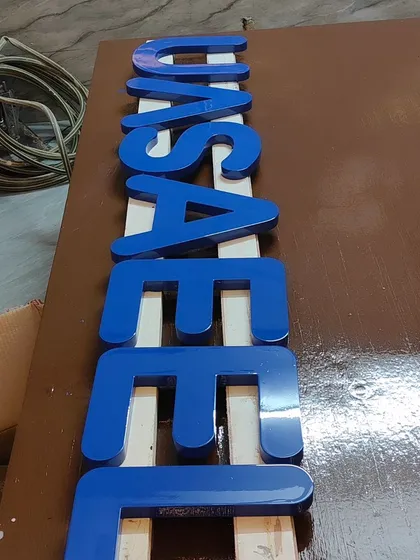 It's not just about wood grain. We also provide high-gloss Duco paint services for a solid, vibrant colour finish. These custom 3D letters for a commercial sign were meticulously spray-painted to achieve a flawless, reflective blue surface.