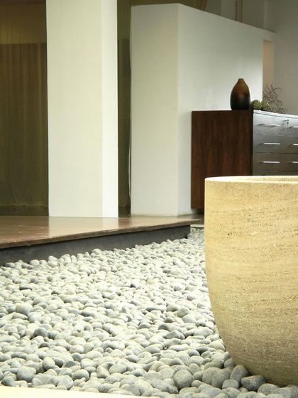 A detail of an indoor pebble garden at the Zanav Home Studio. We often incorporate natural textures and materials into our interiors to create a connection to the outdoors and a sense of tranquility.
