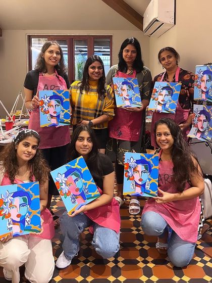 A group of participants with their finished abstract portraits. It's wonderful to see the variety of color choices and personal touches.