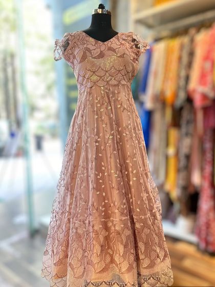 Perfect for a reception or formal event, this blush pink lace gown is the epitome of romance. The delicate lace overlay and cap sleeves create a soft, feminine look that is both timeless and sophisticated.
