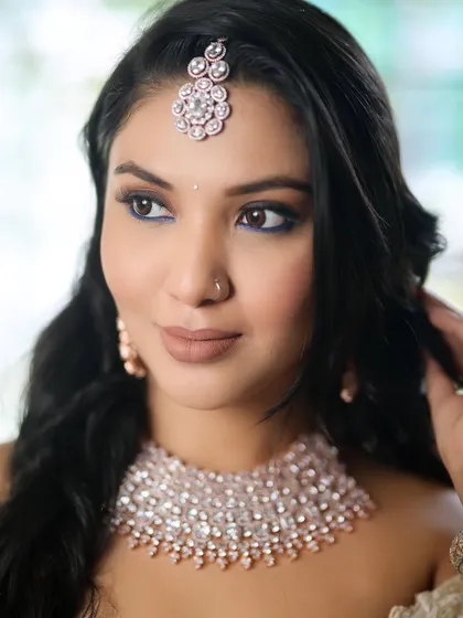 The details matter. This shot highlights the perfectly blended makeup and the way the blue liner makes her eyes pop.