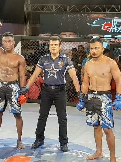 A referee raises our fighter's hand in victory in a professional MMA bout.