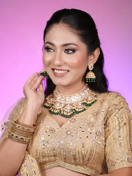 Because soft glam is always a good idea. This model looks radiant in a golden lehenga with soft, glowing makeup and a simple open hairstyle.
