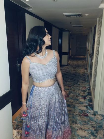 A candid shot of the client, her wavy hair adding a touch of glamour to her overall look. This style is perfect for dancing and celebrating.